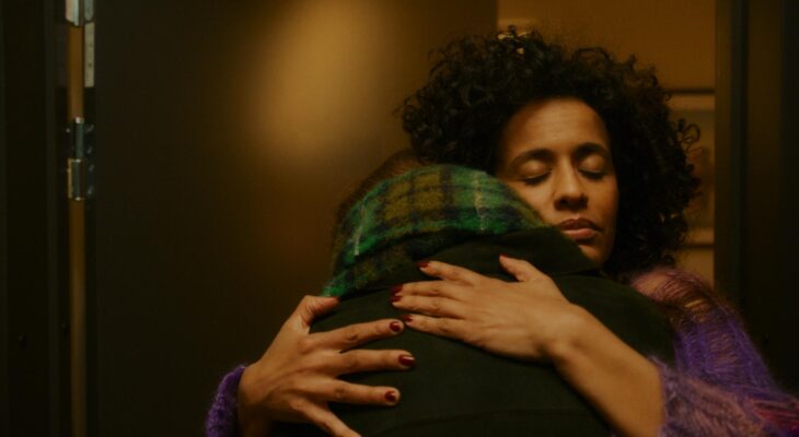 A woman is hugging someone.