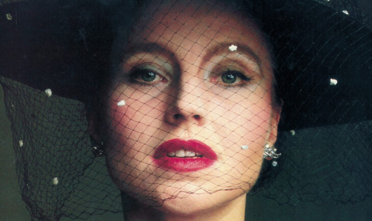 A woman wearing a veil and makeup.